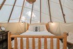Queen bed inside of the teepee